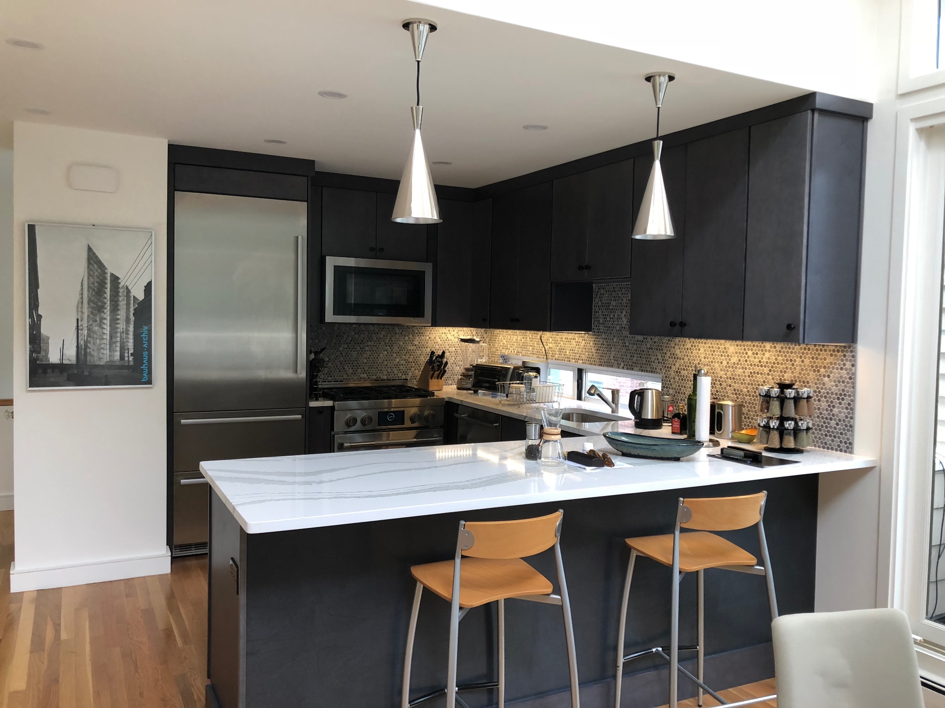 Contemporary dark kitchen with marble countertops